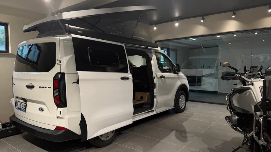 Ford Transit Custom Assos rear three-quarter view with Thule awning and raised pop-up roof