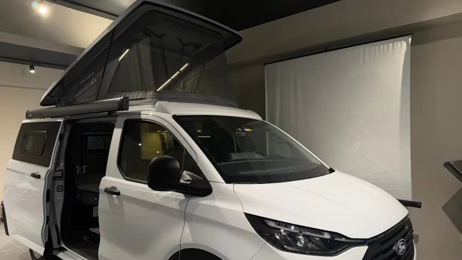 Ford Transit Custom Assos front three-quarter close-up showing the roof bed LED lighting