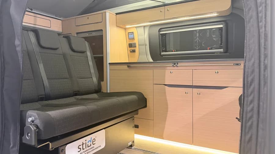 Interior showing the seat system, control panel and camper-type opening window