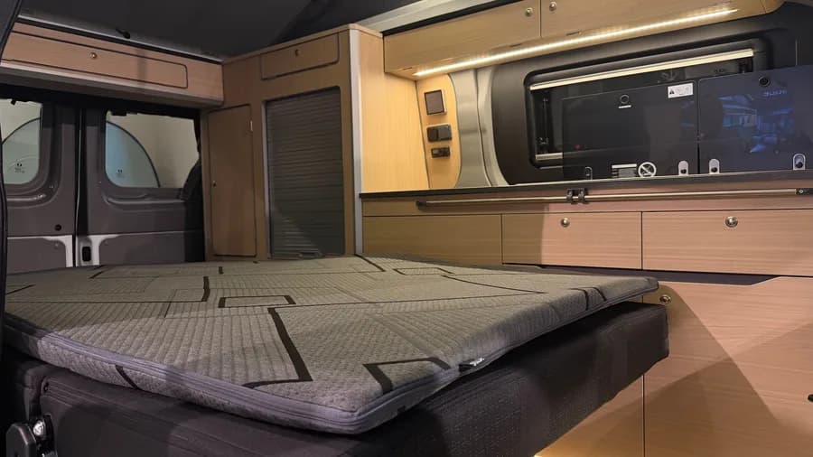 Seat system folded flat into the bed with the mattress topper in place