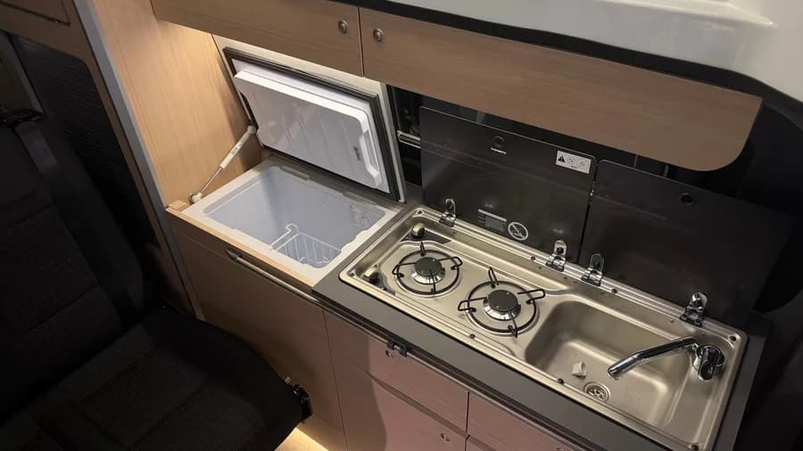 Kitchen detail with the open 40 L Indel compressor fridge, Dometic hob and sink