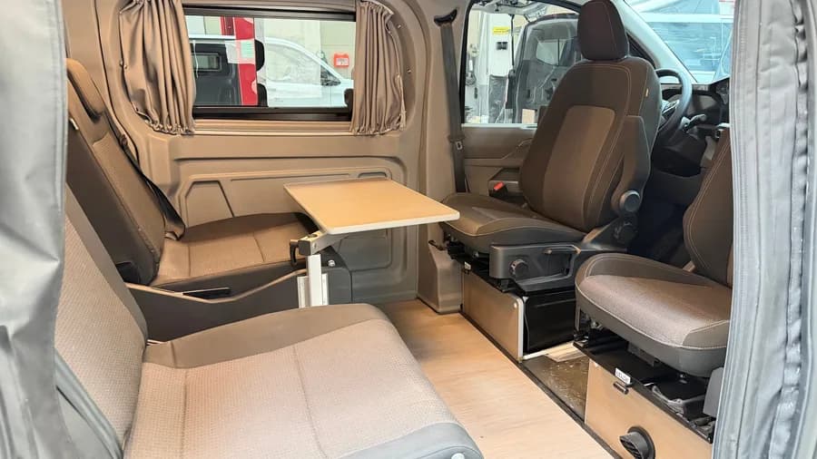 Interior with the STIDE rail seat system, folding table and swivel front seats