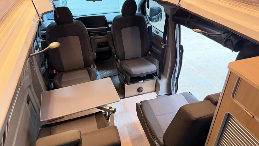 Interior with the swivel front seats, table and the open sliding side door