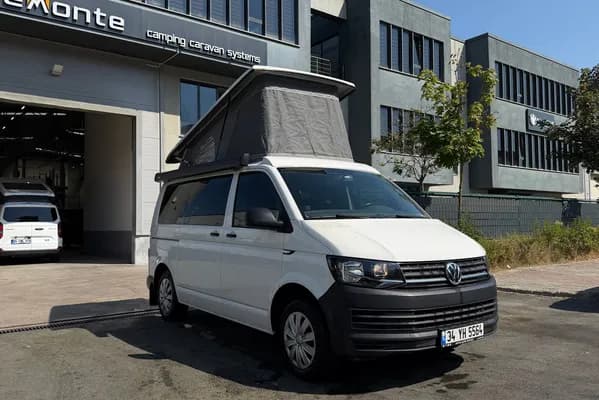 White VW Transporter T6 Cappadocia outside the Demonte Caravan facility with the SCA roof raised