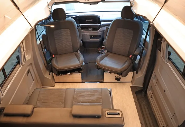 The Efes cabin seen from the open roof, front seats swivelled and the rear converted to a bed