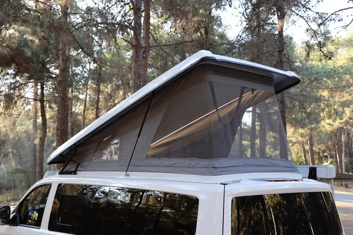 Close-up of the raised SCA pop-up roof on the Efes showing the screened side panel and its tensioned seams