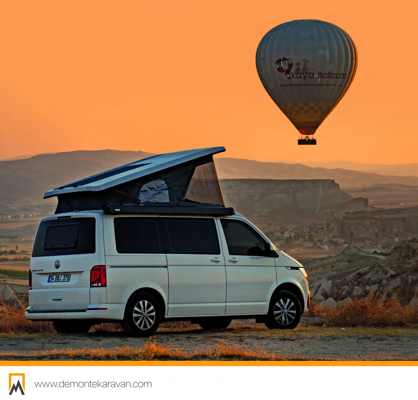 Demonte Karavan 2026 catalogue, page 8: a white VW Transporter with its pop-up roof raised, hot-air balloons over Cappadocia behind it